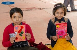 Children show their hand made cards.