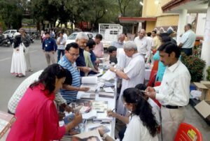 Busy bookshop and information desk after the event, Raipur.