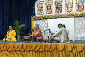 Swami Vasudevananda leads bhajan.