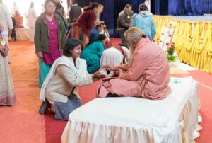 Swamiji distributes prasad.