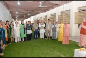 Swami Smaranananda prays during the inauguration of the Registration Booth.