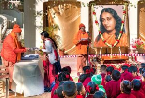 Swami Nityananda distributes gifts.