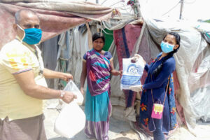 Distribution of foods in slums around Noida Ashram