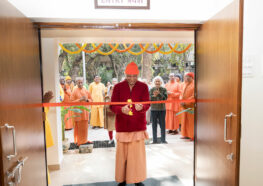 Swami Krishnananda cuts the ribbon.