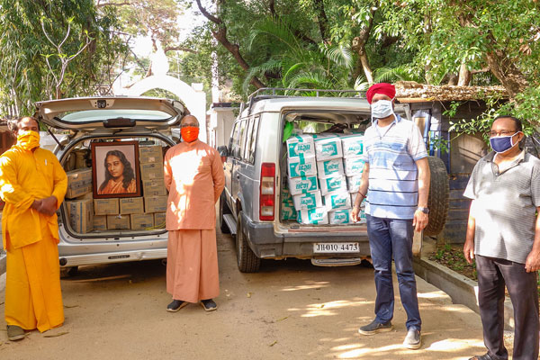 Monks and devotees with relief package for Johna