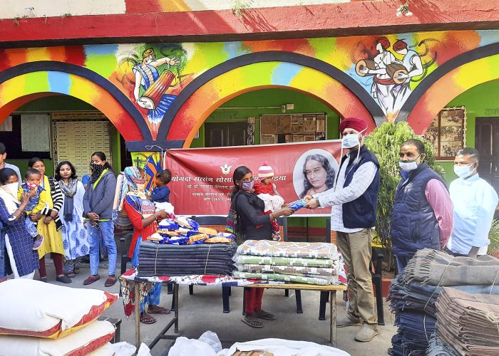 A devotee distributes gifts to an orphanage, Ranchi.