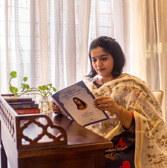 Devotee reading YSS Lesson in self-realization